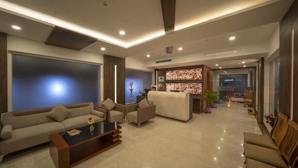 A modern living room with a sofa set, a coffee table, and a decorative vase.