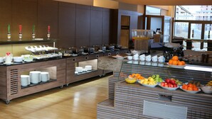 Een modern ontbijtbuffet met diverse etenswaren en een koffiehoek.