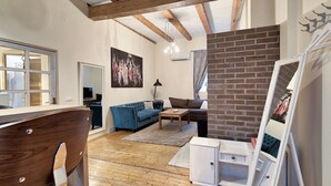 A living room with a blue sofa, a wooden coffee table, and a white cabinet.