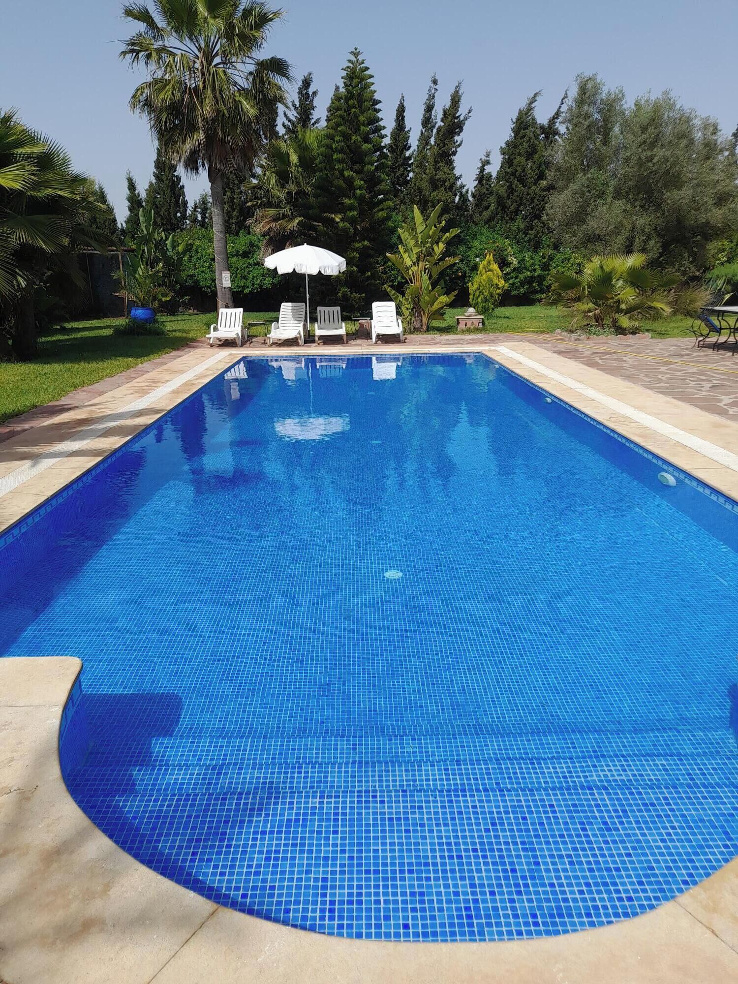 Outdoor pool, open 6:00 AM to 10:00 PM, pool loungers