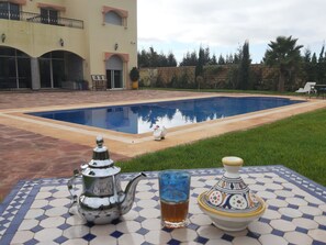 Outdoor pool, open 6:00 AM to 10:00 PM, sun loungers