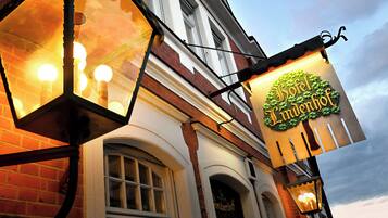 Hotel Lindernhof's classic facade features a prominent sign and elegant white trim.