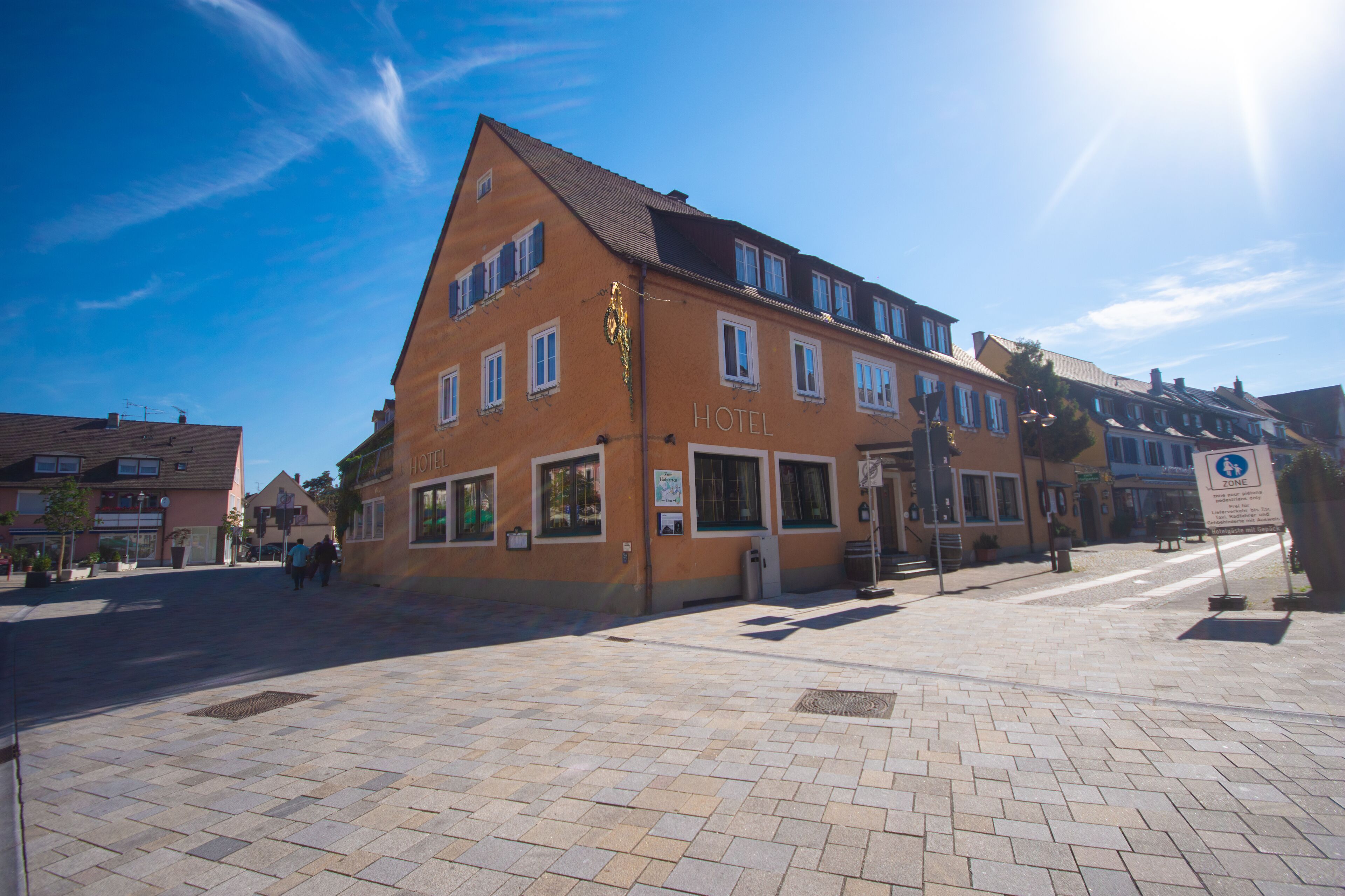 A hotel with a traditional European architectural style, featuring a prominent entrance and multiple windows.