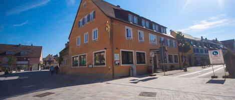 A hotel with a traditional European architectural style, featuring a prominent entrance and multiple windows.