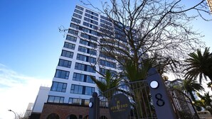 A modern building with a sign reading "Hereford Residences" and a gated entrance. - 2 Bed Apt Heart of Ponsonby Gym (Auckland)