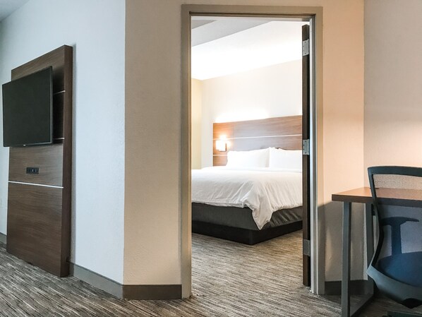 A hotel room with a bed, a television, and a desk with a chair. - Holiday Inn Express Statesboro by IHG (Statesboro)