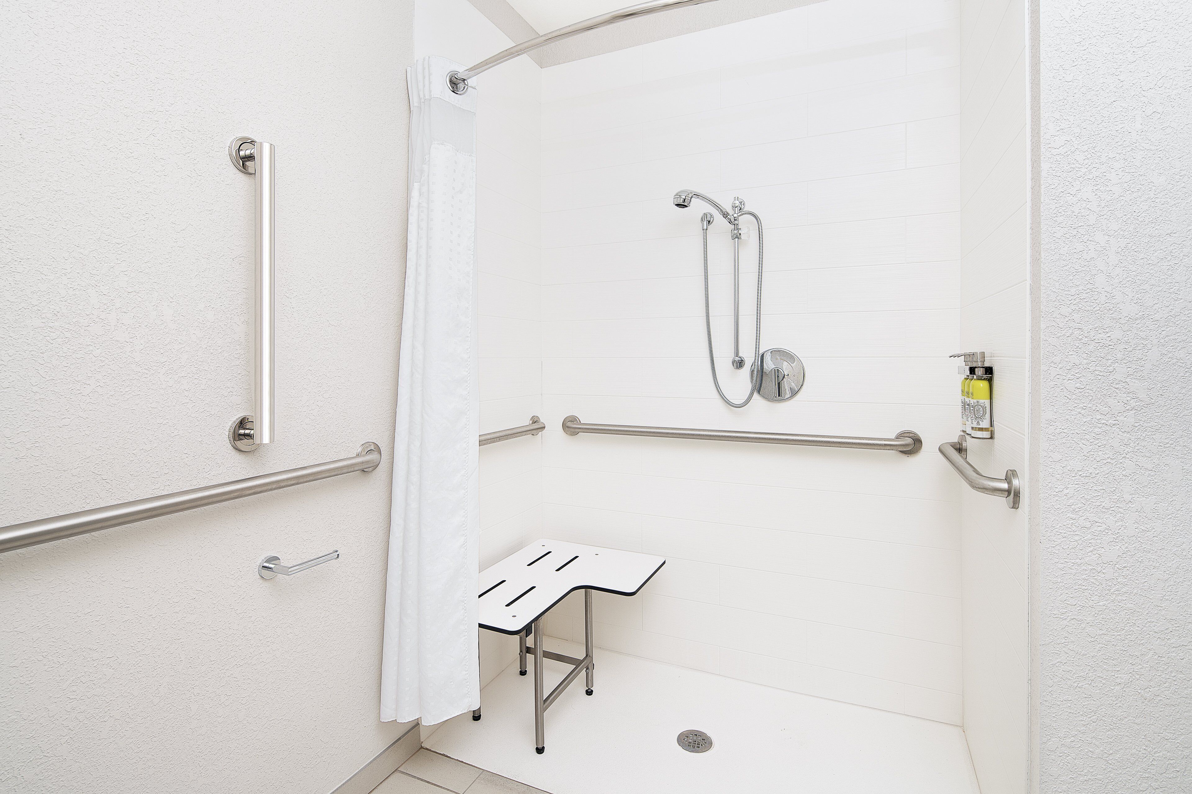 combined shower/bathtub, designer toiletries, hair dryer, towels