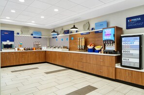 A modern breakfast area with a self-serve station, including options for cereal, fruit, yogurt, eggs, and milk. - Holiday Inn Express Statesboro by IHG (Statesboro)