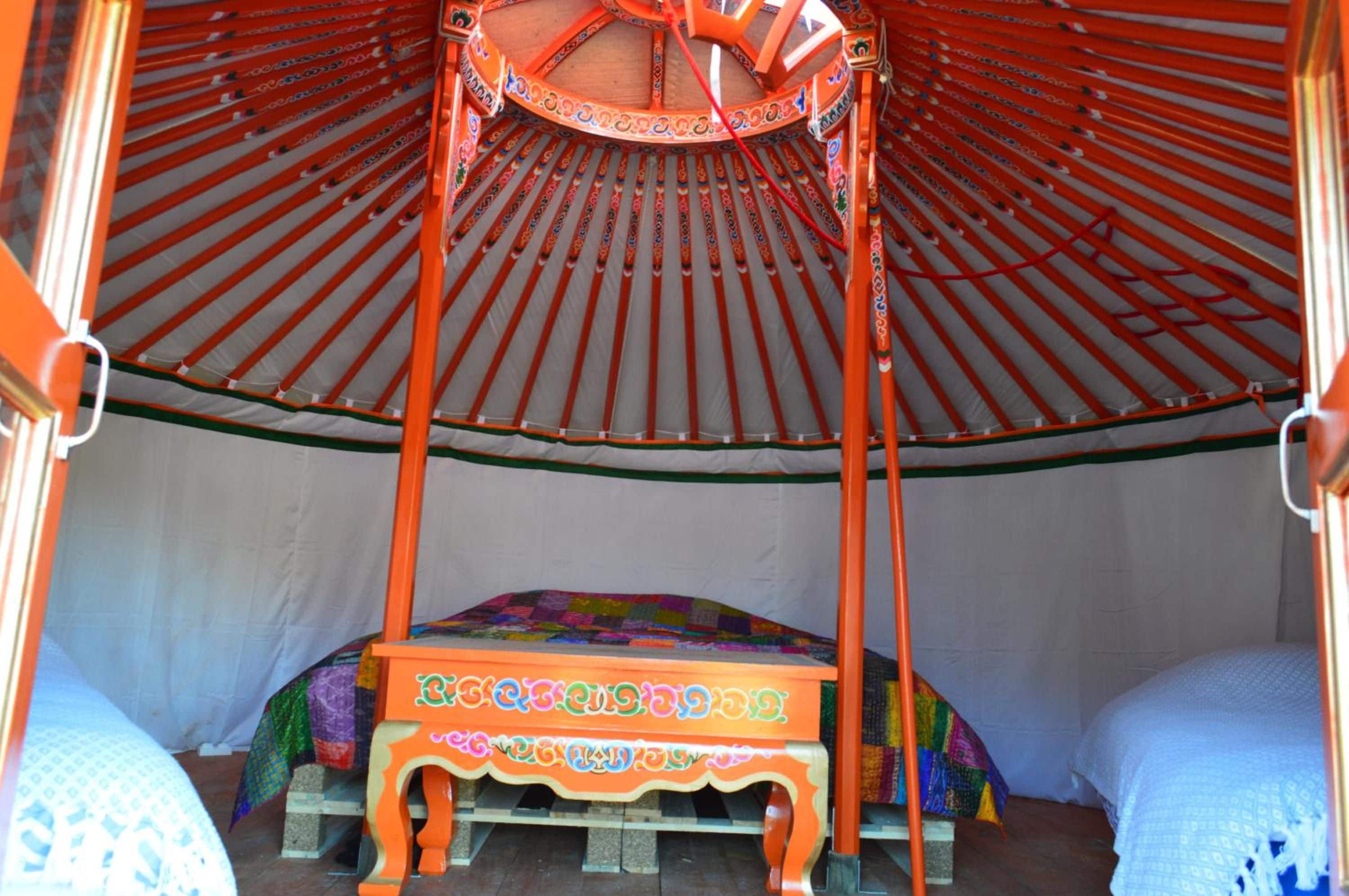 A traditional tent with a four-poster bed inside.