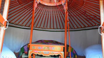A traditional tent with a four-poster bed inside.