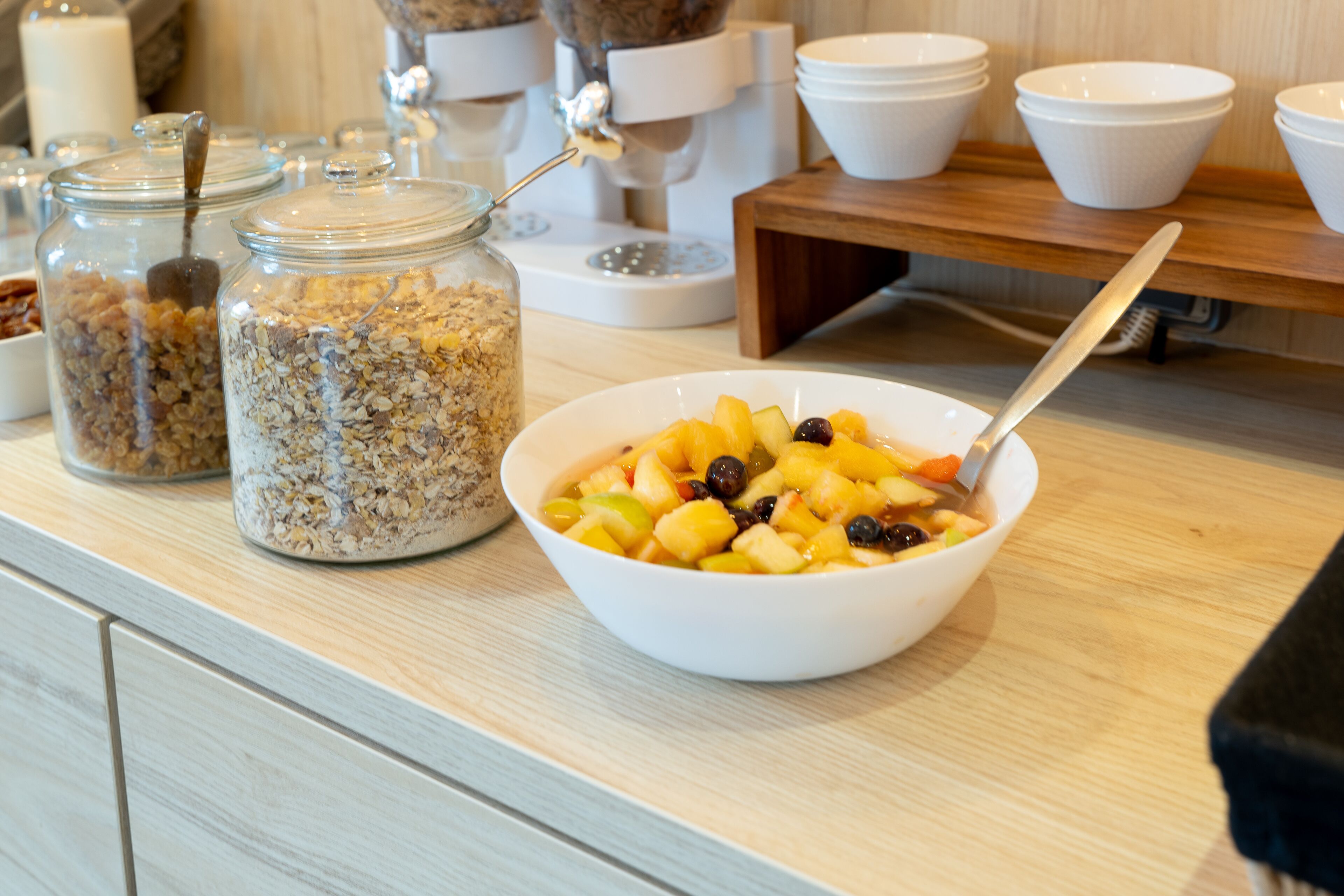 A breakfast buffet with various food items and containers.