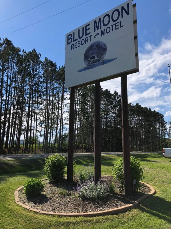 A sign for Blue Moon Resort and Motel with a circular emblem. - Blue Moon Resort and Motel (Hill City)