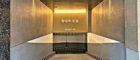 A modern elevator shaft with metallic walls and a patterned floor.