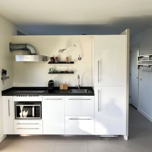 Enjoy cooking in this well-equipped kitchen with an oven, microwave, and stainless steel range hood.