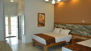 A hotel room with a wooden bed, a painting on the wall, and a view of the outdoors.
