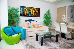 Luxury Apartment, Ocean View | Living area | 55-inch LED TV with cable channels, TV