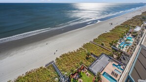 A beachfront hotel with a pool area, a beach, and ocean views. - Ashworth 1809 4 Bedroom Condo by RedAwning (North Myrtle Beach)