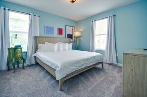 A bedroom with a bed, a nightstand, a lamp, and a dresser. - Villa in Champions Gate Resort 2527 (Davenport)
