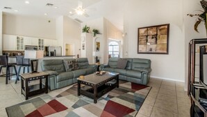 A spacious living room with a large sectional sofa, a coffee table, and a patterned rug. - Beautiful Villa With Private Pool, Orlando Villa 1488 (Davenport)