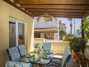 A covered patio with a table set for two, featuring blue patterned chairs and a glass table. - Beautiful Villa With Private Pool, Protaras Villa 1010 (Paralimni)