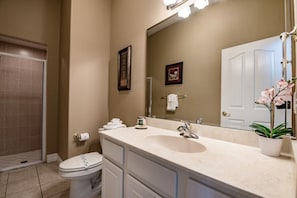 A bathroom with a sink, mirror, toilet, and a shower area. - Orlando Villa for Rent With Gorgeous Pool, Vistapark Resort, Villa Orlando 1478 (Davenport)