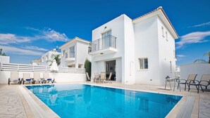 A modern two-story building with a swimming pool, outdoor seating, and a clear blue sky. - Luxury 3 Bedroom Villa With Private Pool, Paralimni Villa 1290 (Paralimni)