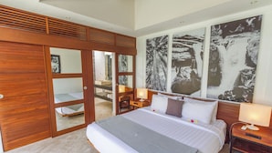 A bedroom with a large bed, wooden wardrobe, and a bathroom visible through a glass door. - Private Villa in Seminyak 1146 (Seminyak)