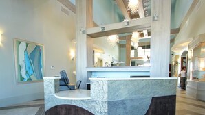 A reception area with a marble counter, a chair, and a large abstract painting on the wall. - Private Resort Home 1131 (Davenport)