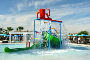 A water park with a water slide and a pool. - Villa in Windsor at Westside Resort 1769 (Kissimmee)