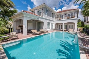A large house with a swimming pool, multiple balconies, and outdoor seating areas. - Villa in Reunion Resort & Spa 2976 (Kissimmee)