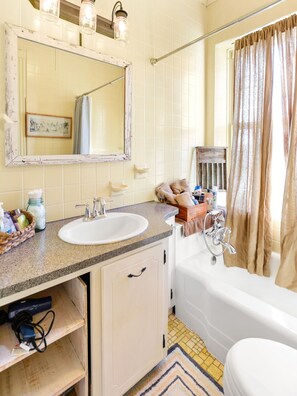 Een bad, een haardroger, handdoeken, toiletpapier