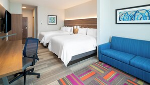 A hotel room with two beds, a desk, a blue sofa, and a TV. - Holiday Inn Express & Suites St Peters by IHG (St. Peters)