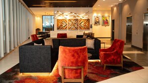 A modern lobby with a reception desk, seating area, and elevators. - Hyatt Place Chicago/Wicker Park (Chicago)