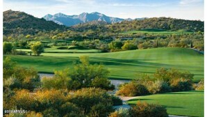 A golf course with rolling green hills, trees, and mountains in the background. - Modern home in Estrella Mtn Ranch - refreshing Pool & Spa / Fire pit / Mtn Views (Goodyear)