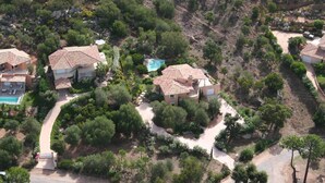 An aerial view of a residential area with multiple houses, a swimming pool, and a well-maintained garden. - CAEDA VILLA - PRIVATE SWIMMING POOL - SAINT CYPRIEN (SAINTE-LUCIE DE PORTO-VECCHIO)