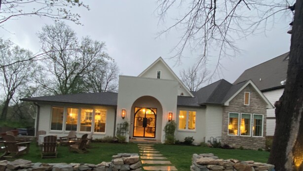 A house with a stone pathway leading to a large arched entrance, surrounded by a well-maintained lawn and stone walls. - Stunning Home in Historic Franklin, TN

Walk to Downtown, pickleball, & coffee! (Franklin)