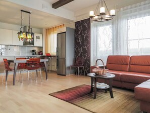 A modern living space with a kitchen, dining area, and seating area.