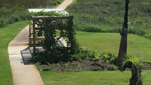 A pathway leading to a gazebo with a view of the ocean.
