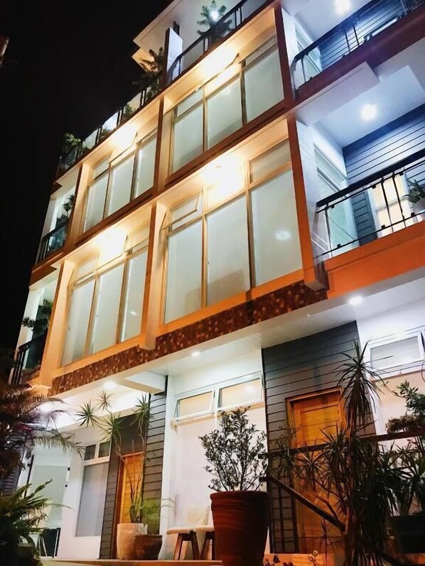 A multi-story building with large windows and balconies.