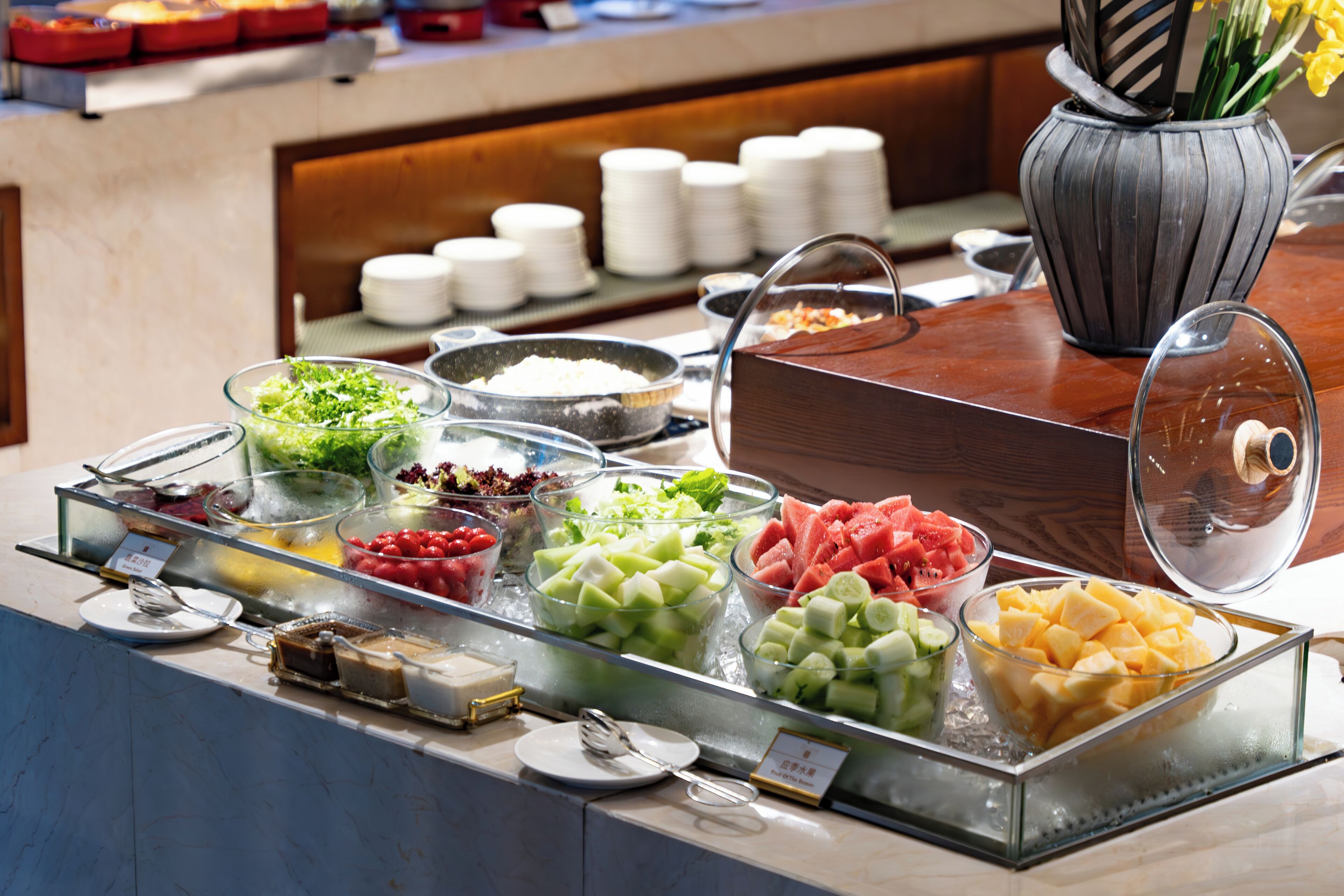 A buffet with various fruits and desserts.