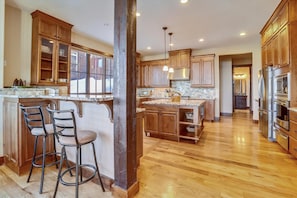 Enjoy cooking in this well-equipped kitchen with a central island, stainless steel appliances, and ample counter space.