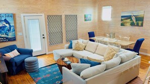 A cozy living room with a sectional sofa, a coffee table, and a patterned rug. - Hot Tub, Pool, Paradise Pointe, 75" TV, balcony, Blackouts Opt Studio (Port Aransas)