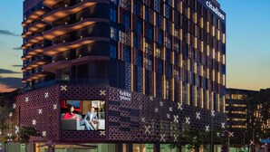 A modern hotel with a unique facade featuring balconies and a prominent 'Citadines' sign. - Citadines Rochor Singapore (Singapore)