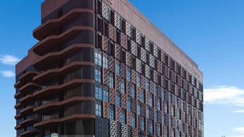 A modern hotel with a unique facade featuring geometric patterns and balconies.