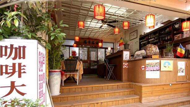 A traditional Japanese restaurant with wooden steps leading to the entrance, a signboard with Japanese characters, and a warm interior with hanging lanterns. - Coffee Street Homestay (Gukeng)