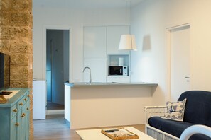 A compact living space with a kitchenette, a dining area, and a seating area.