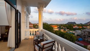 A balcony with a view of a cityscape, including buildings and mountains. - Trang An International Hotel (Tay Hoa Lu)