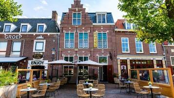 A traditional European building with a cafe and outdoor seating area.