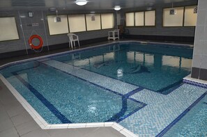 An indoor swimming pool with clear water, tiled edges, and a 'No Diving' sign. - Al Jazeera Hotel Apartments LLC (Dubai)