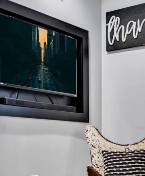 Relax in a spacious living area with a large flat-screen TV and a cozy seating area.